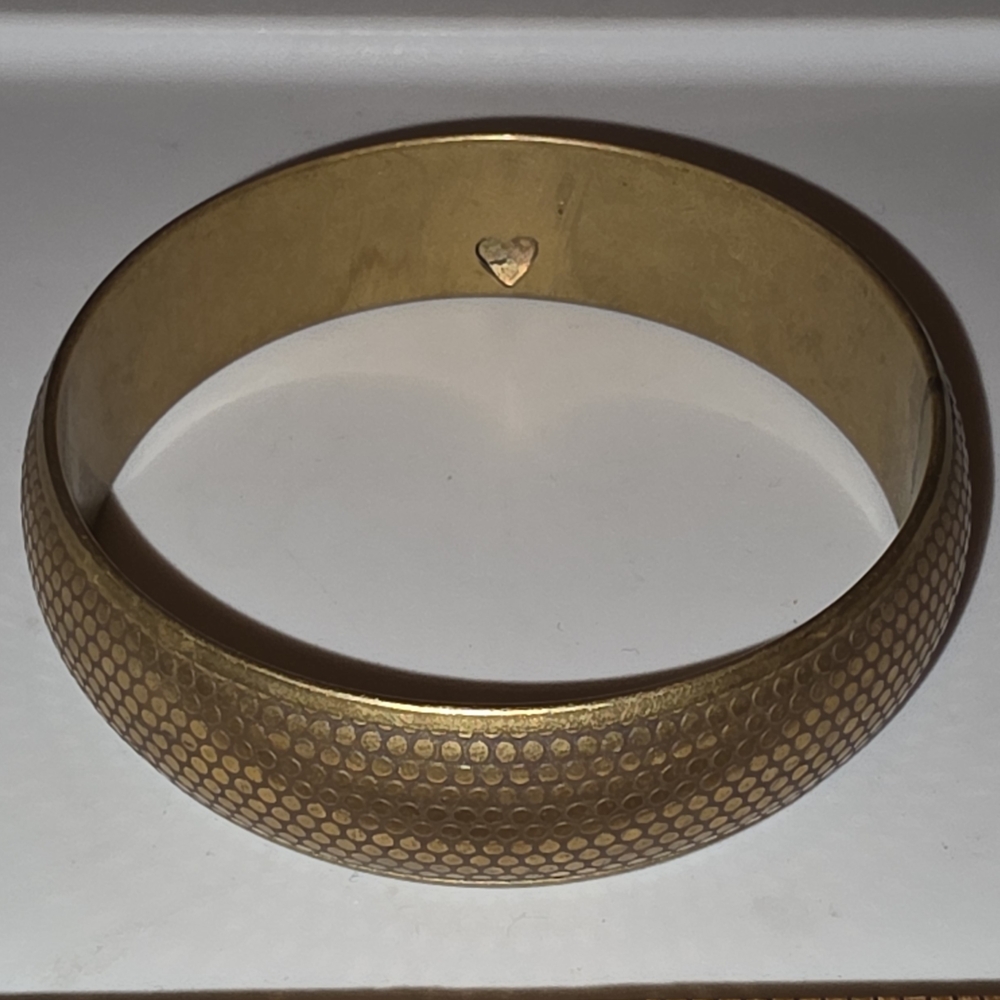 Gold-tone bangle with a textured mesh design